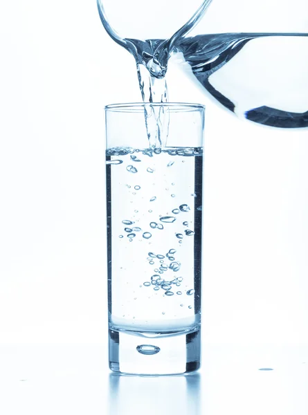 Pouring water from a pitcher — Stock Photo, Image