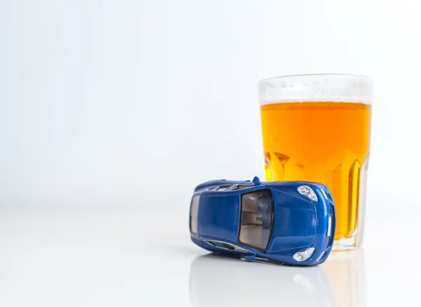 Glass with alcohol and car — Stock Photo, Image