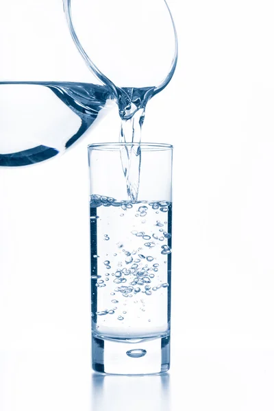 Pouring water from a pitcher — Stock Photo, Image