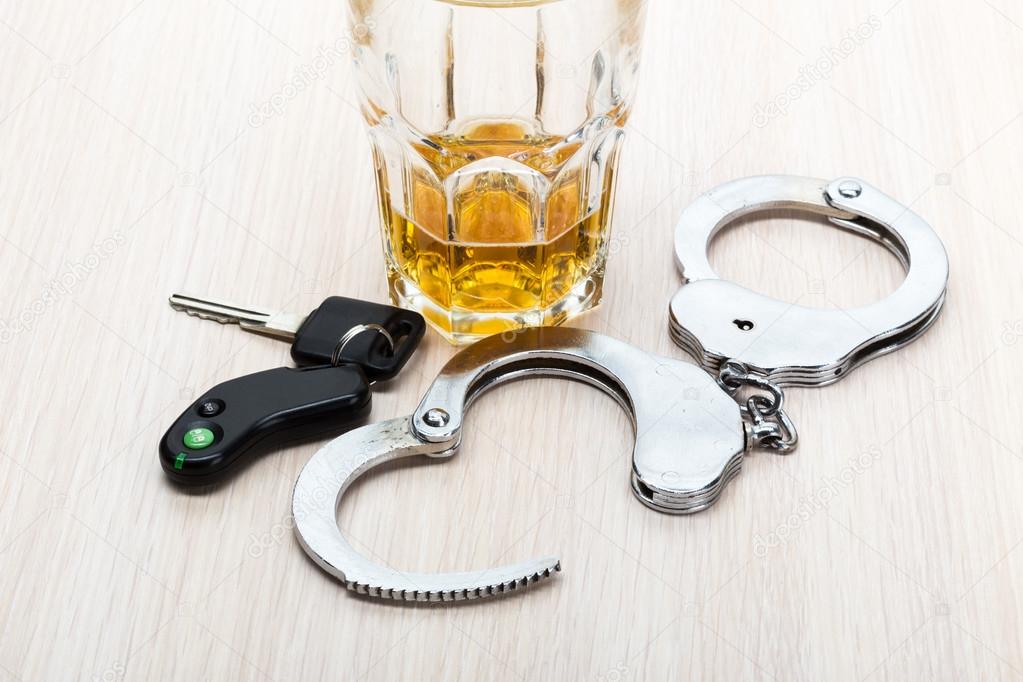 alcohol car keys and handcuffs