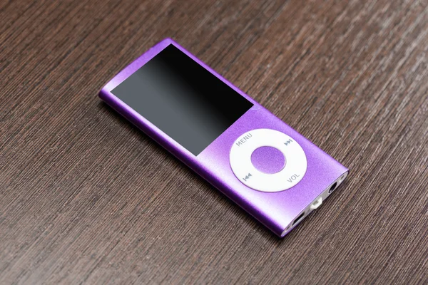 Purple ipod on desk — Stock Photo, Image