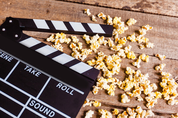 Movie clapperboard and popcorn 