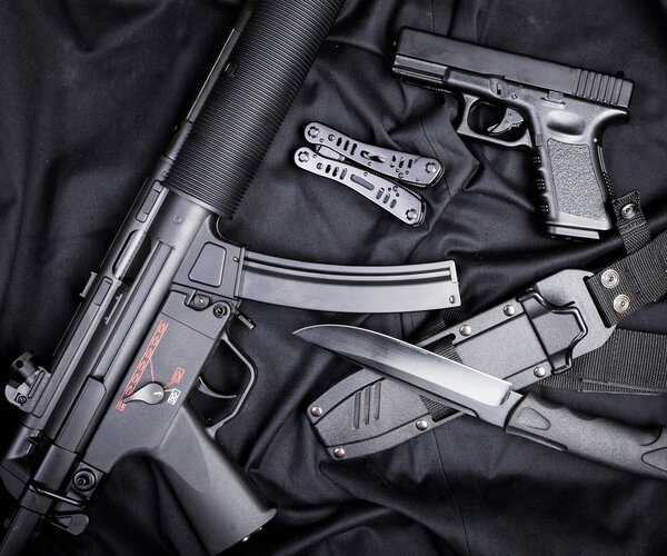 set of guns on black cloth