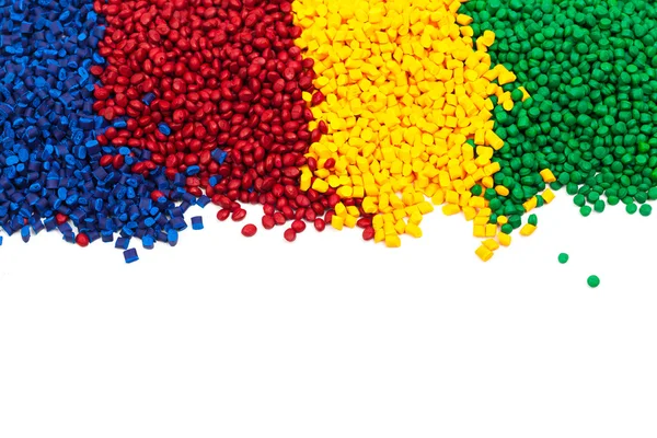 Heaps of spectrum colored tinted plastic granulates — Stock Photo, Image