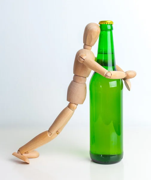Wooden doll with bottle — Stock Photo, Image