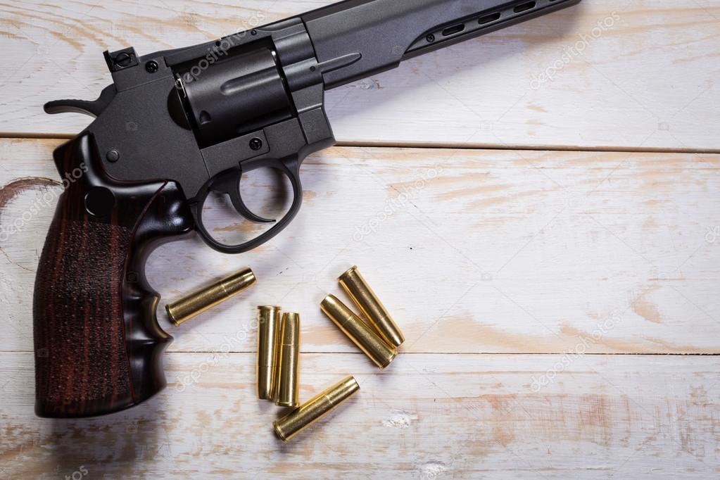 hand gun with bullets on desks