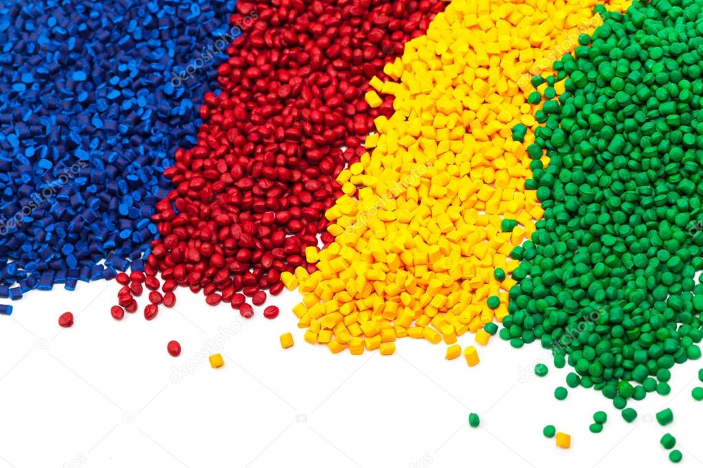 heaps of spectrum colored tinted plastic granulates 