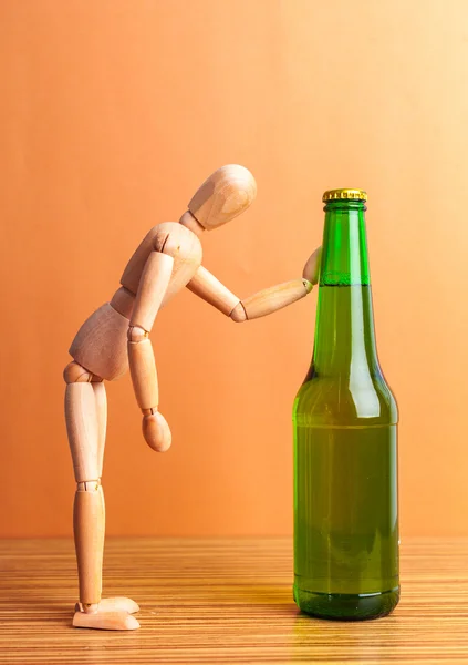 Деревянная кукла с бутылкой — стоковое фото