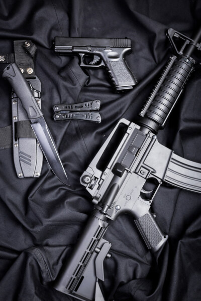 set of guns on black cloth