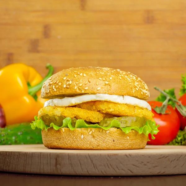 Burger with vegetables on the background — Stock Photo, Image