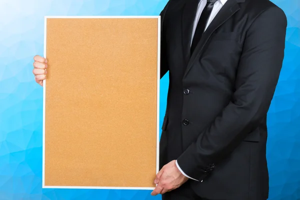 Businessman holding blank picture frame — Stock Photo, Image