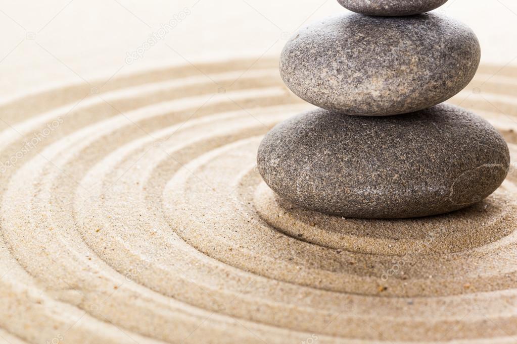 Three stones on sand 