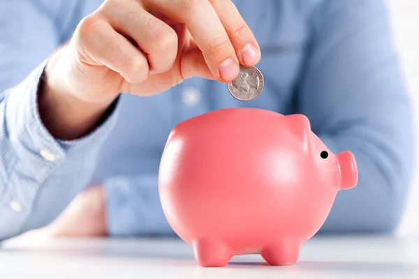 Piggy bank and hand — Stock Photo, Image