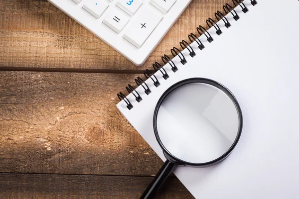 magnifying glass on the wooden background