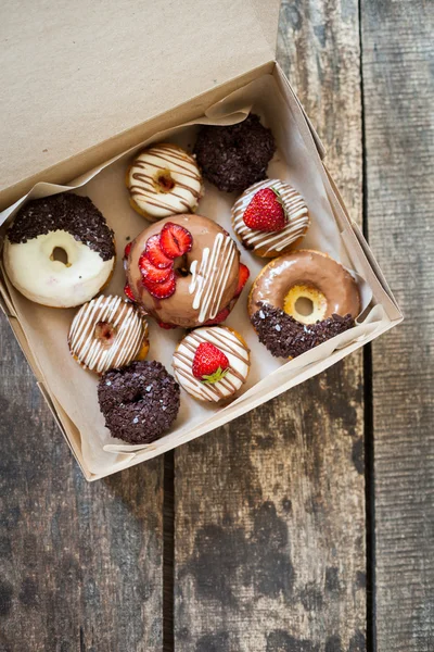 Colorful donuts in carton box