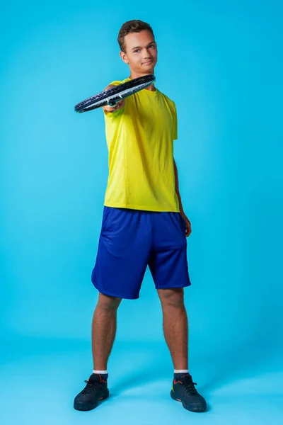 Full length studio portrait of a tennis player man on blue background — Stock Photo, Image