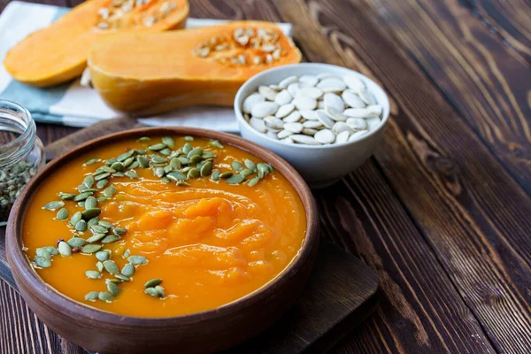 Creamy pumpkin soup on a wooden table — Stock Photo, Image