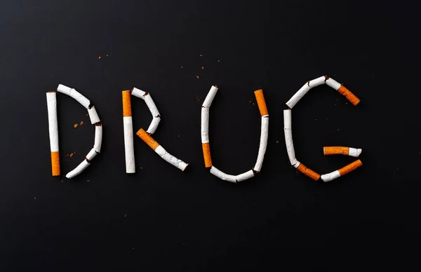 Inscription word DRUG made out of cigarettes top view — Stock Photo, Image