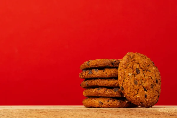 stock image Chocolate chip cookies in stack on red background