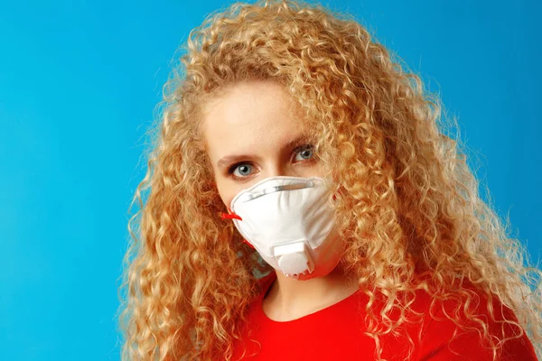 Beautiful young lady with curly hair wearing medical face mask