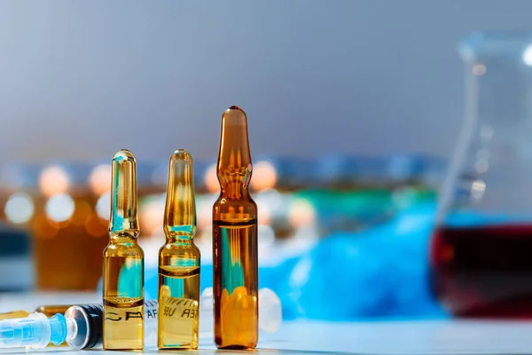 Vial of vaccine bottle with a syringe close up