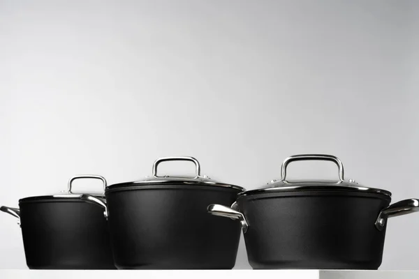 New domestic cookware on grey background close up — Stock Photo, Image