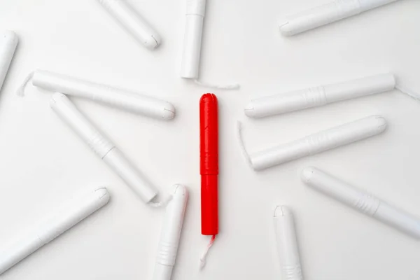 Red and white woman medical tampons on white background