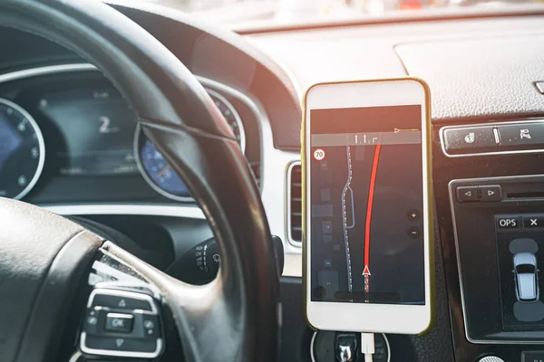 Smartphone with open gps navigation app on torpedo in car — Stock Photo, Image