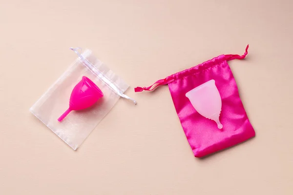 Two menstrual cups on beige background top view — Stock Photo, Image