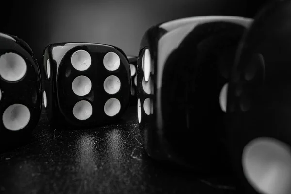 Group of playing dice cubes on black surface, macro — Stock Photo, Image