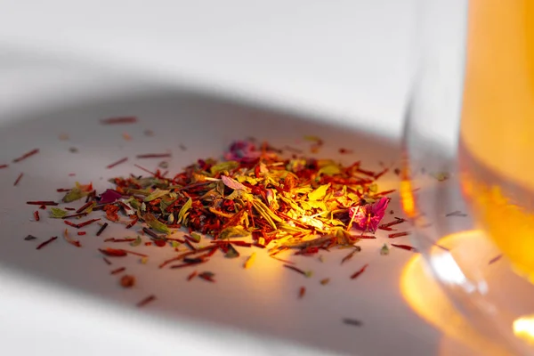 Colorful dry tea herbs heap on white surface — Stock Photo, Image