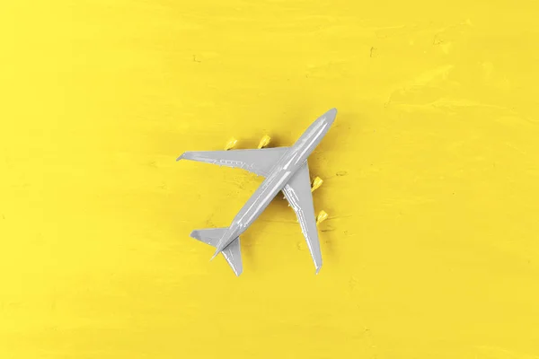 Toy plane on Illuminating Yellow background, top view — Stockfoto