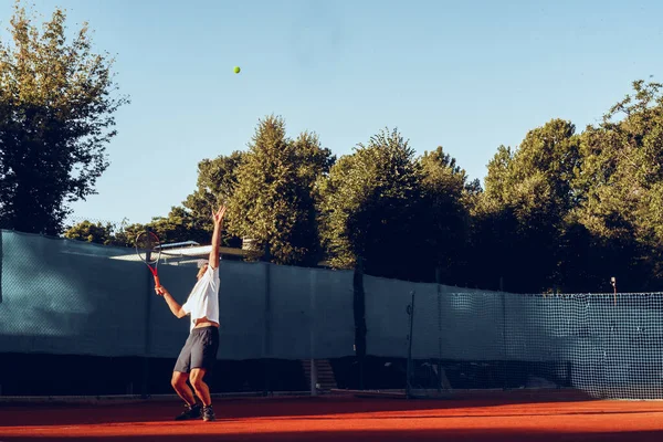 Ung proffesionell tennisspelare gör en serve — Stockfoto