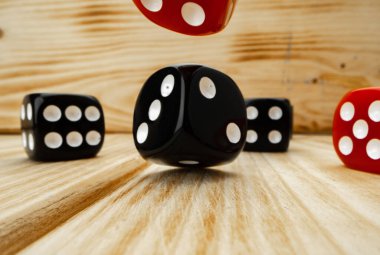 Ahşap arkaplanda kırmızı ve siyah zar küpleri