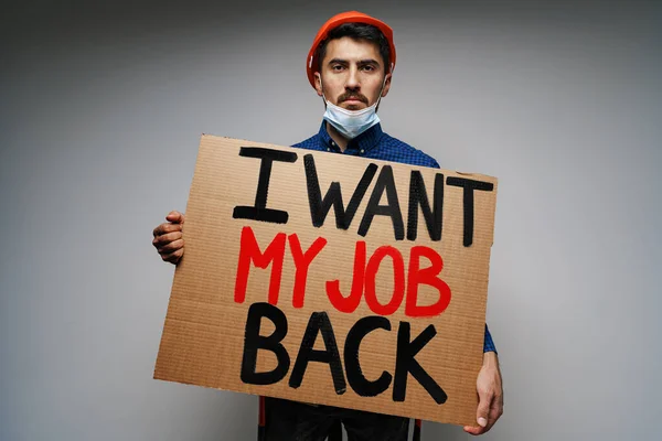 Placard I want my job back in hands of protester man wearing mask. — Stock Photo, Image