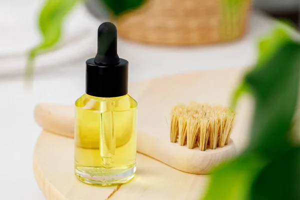 Botella de aceite cosmético amarillo en bandeja de madera de cerca — Foto de Stock