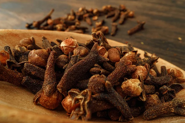 Heap of clove spice on wooden table — Stock Photo, Image