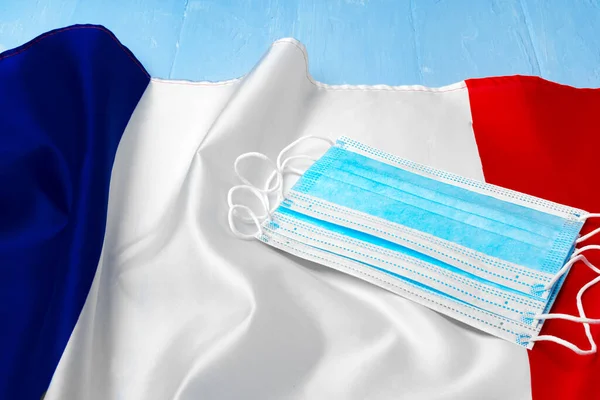 Medical mask on national flag of France — Stock Photo, Image