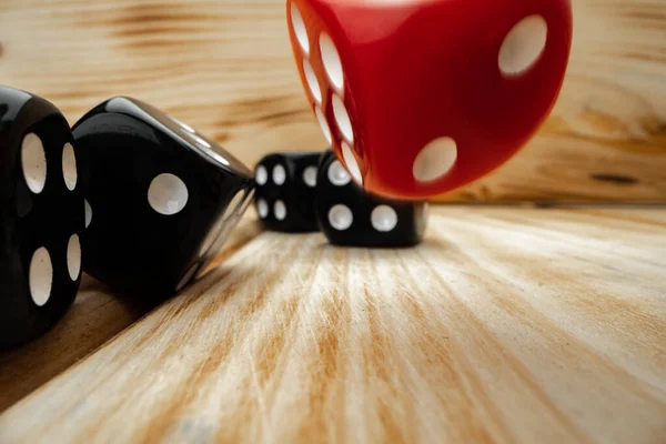 Red and black dice cubes on wooden background — Stock Photo, Image