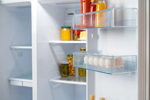 Glass jars of canned products on a fridge shelf — Stock Photo, Image