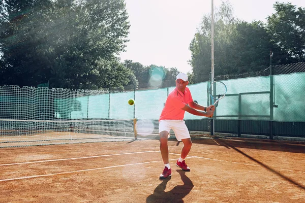 Mann mittleren Alters spielt Tennis im Freien — Stockfoto