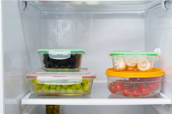 Storage containers with fresh food in a fridge