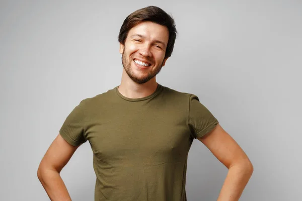 Handsome young man portrait smiling against grey background — Stock Photo, Image