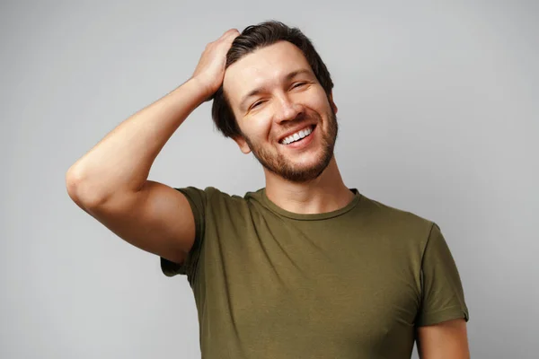 Guapo joven retrato sonriendo sobre fondo gris — Foto de Stock