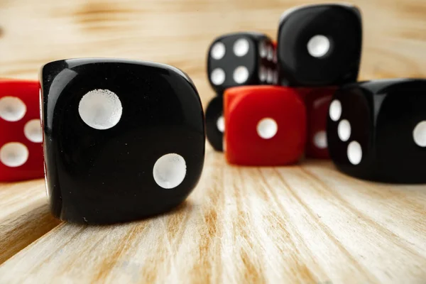 Red and black dice cubes on wooden background — Stock Photo, Image