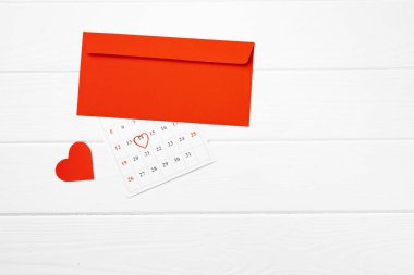 Ahşap zemin üzerinde kırmızı kalpli zarf