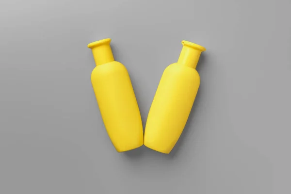 Yellow cosmetic container on gray background top view — Stock Photo, Image