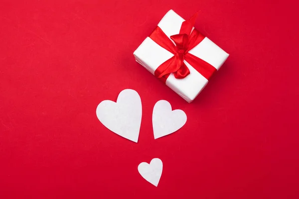 Cadeaudoosje, rode papieren hartjes. Valentijnsdag absctract. Symbool van de liefde. Kopieerruimte, platte lay — Stockfoto