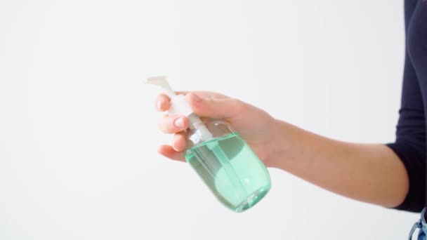 Gel disinfettante mani applicante femminile su sfondo bianco — Video Stock