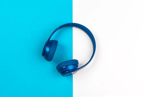 Blue headphones on blue and white color background — Stock Photo, Image